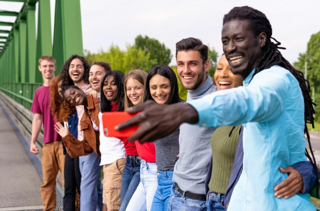 Cheerful international happy friends taking selfies during travel in Spain