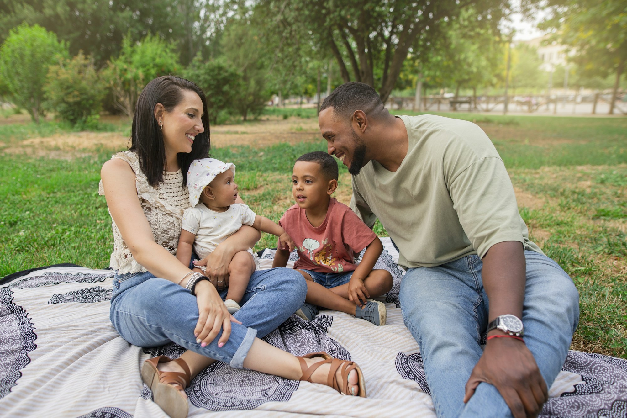 Happy family spanish-latin with their children in the park